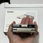Aurzen ZIP Tri-Fold DLP Truly Mini Projector. Pocket Size. Zero-Lag Focus. One-Click Screen Mirroring. Full-Screen Mode. Type-C Fast Charging. 5.000mAh Battery. Indoor Outdoor Portable Projector.Gold